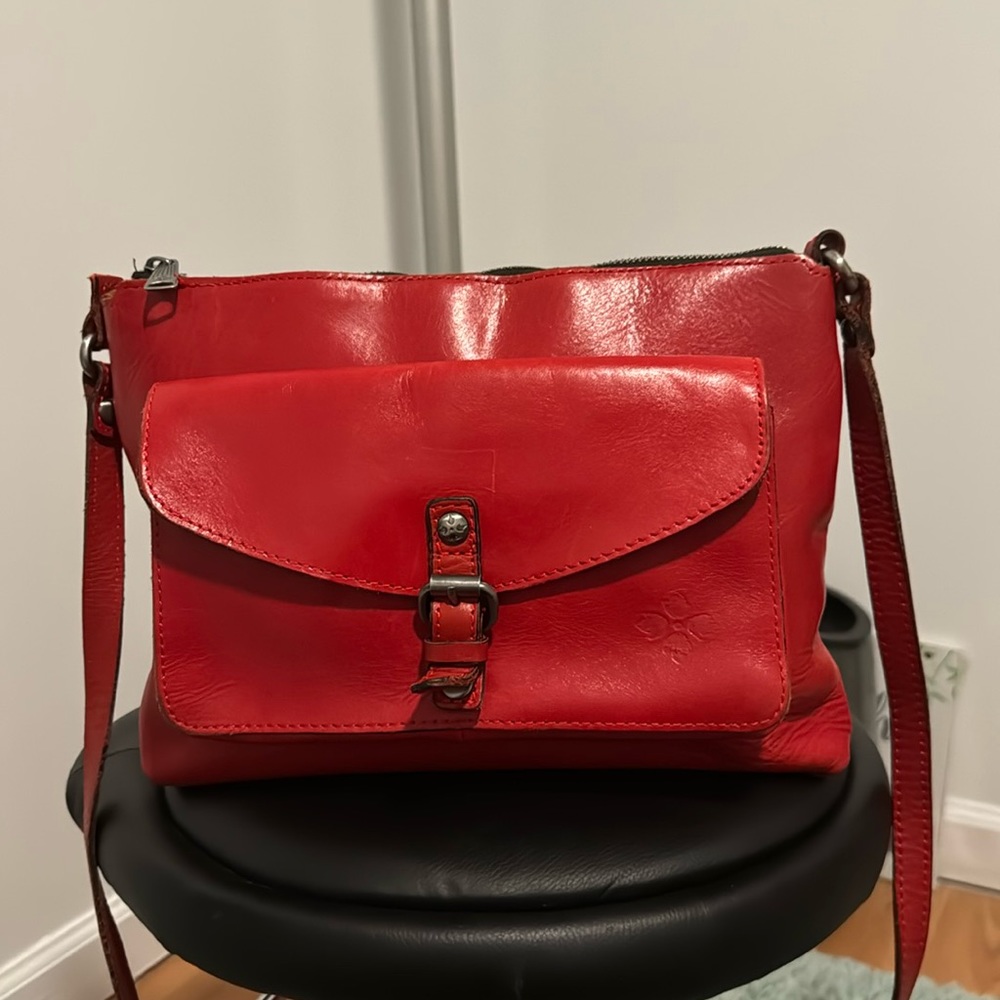 red shoulder bag, Patricia Nash has a little loose tread in the stripe.
